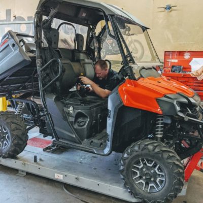 Chris working on a side by side UTV vehicle for DW Powersports Woodburn Oregon